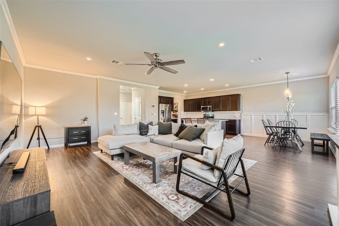 a living room with furniture or kitchen view and a wooden floor