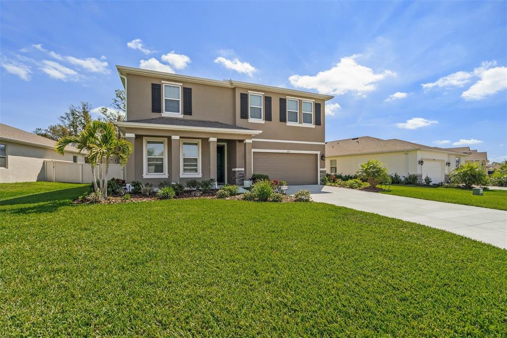 a front view of a house with a yard and garage