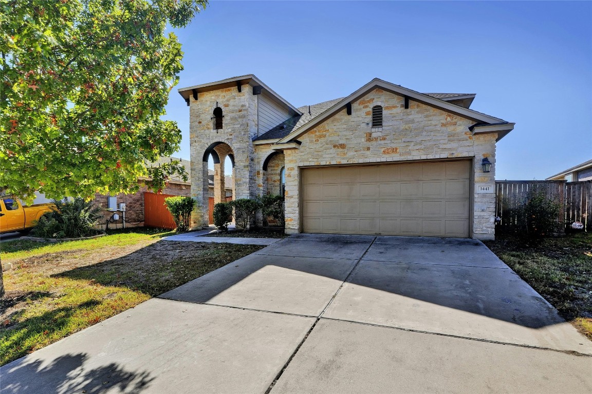 a front view of a house with garage