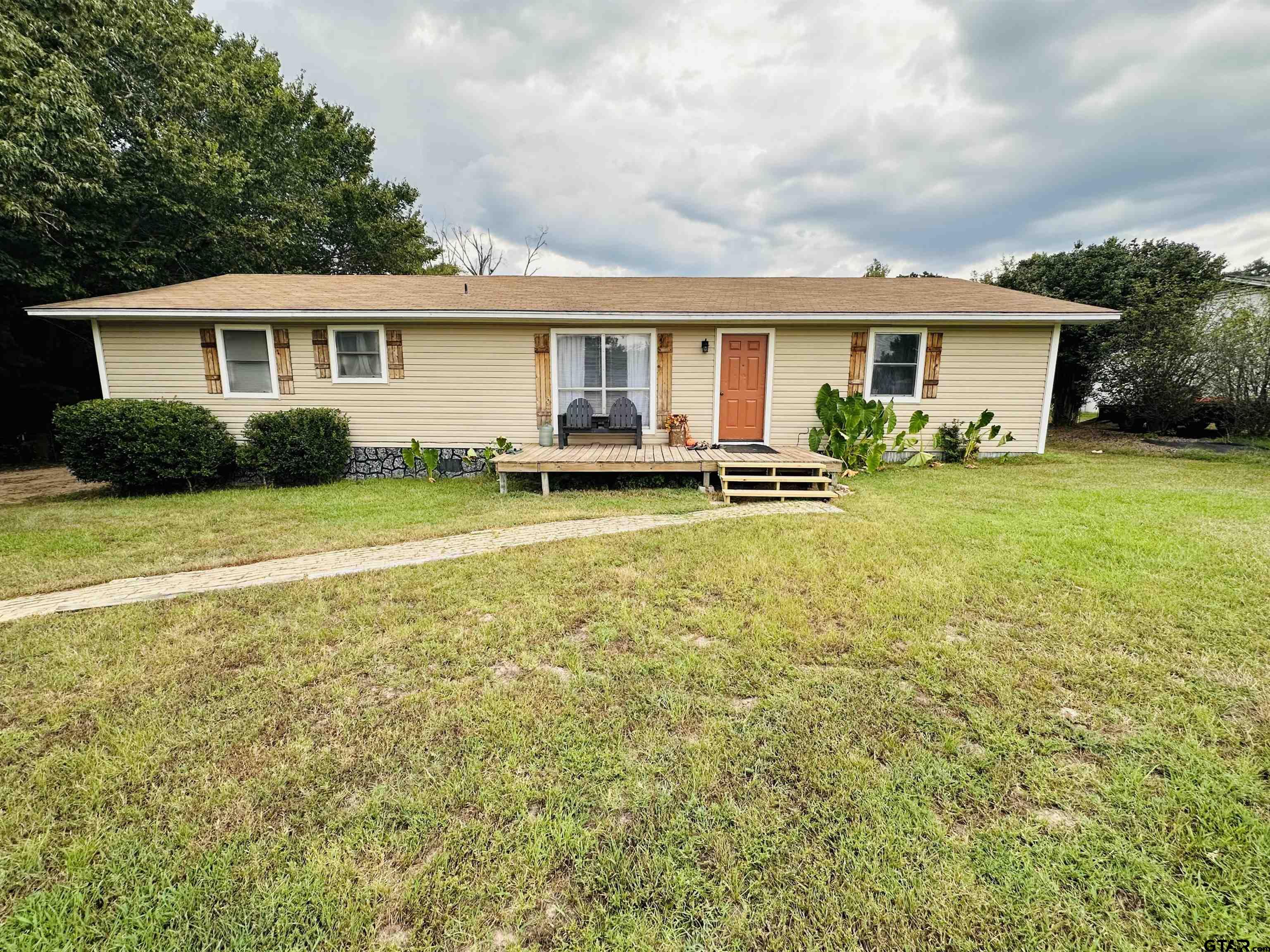 a view of a house with a yard and sitting area