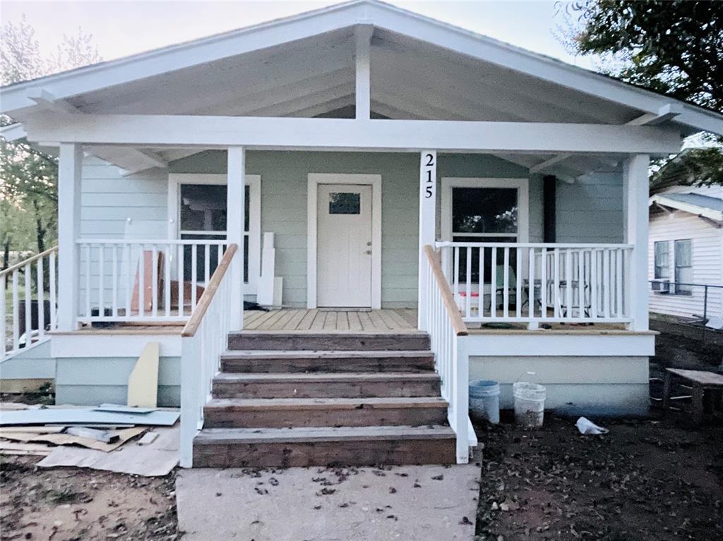 a view of a house with wooden floor and a yard