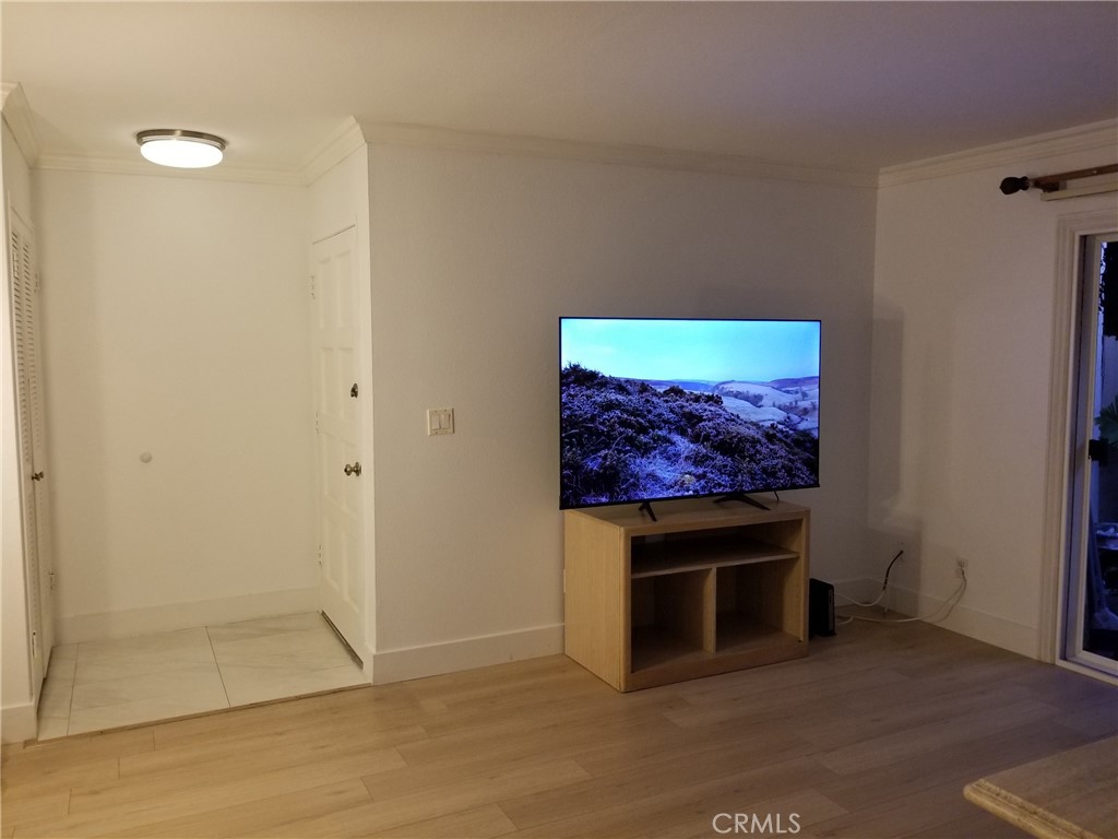 an empty room with wooden floor and a fireplace