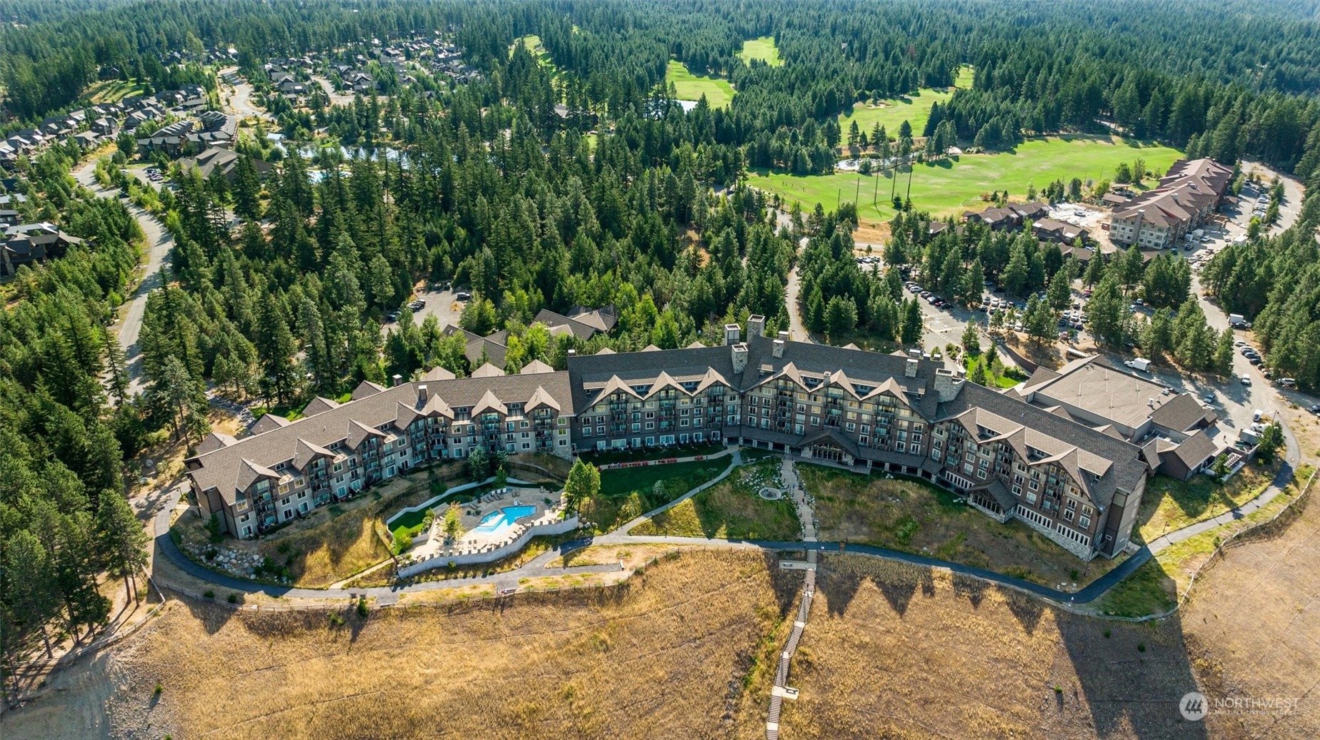 an aerial view of a house with a yard basket ball court and outdoor seating