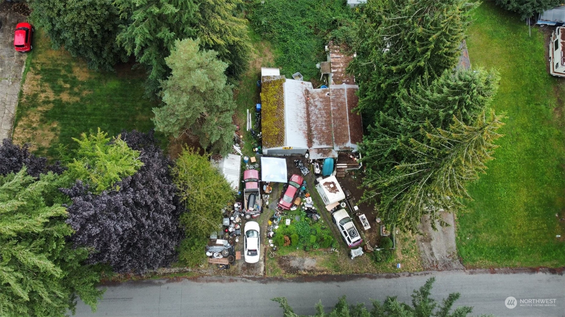 an aerial view of a residential apartment building with a yard and garden