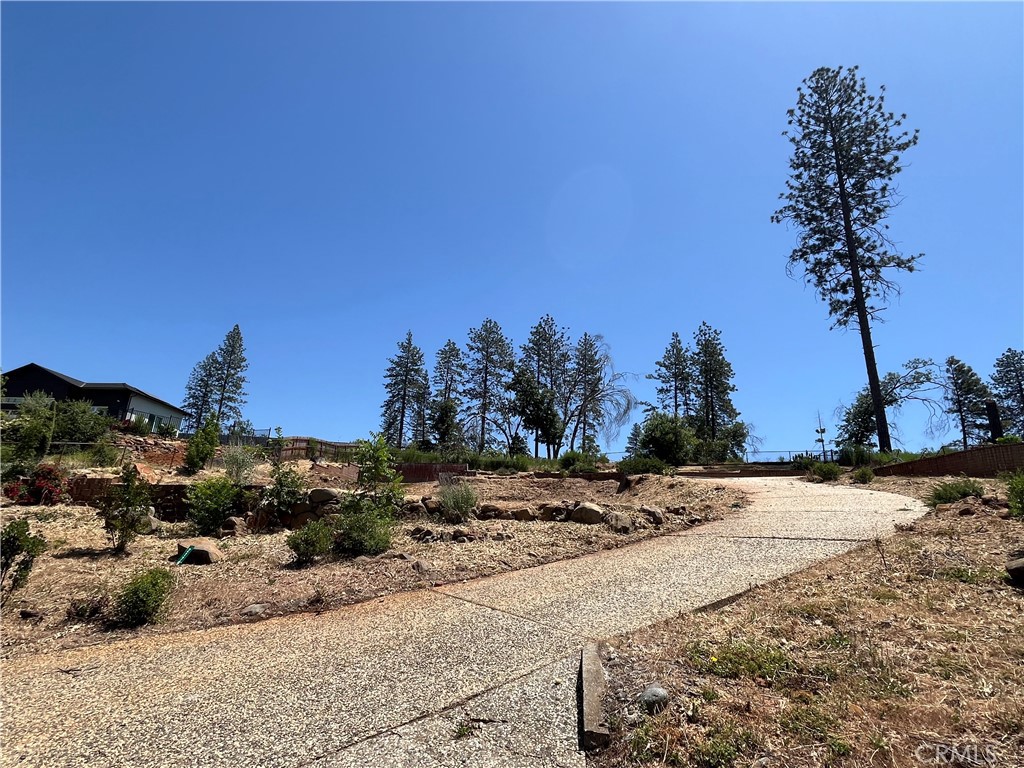 a view of a dirt road with a building in the background