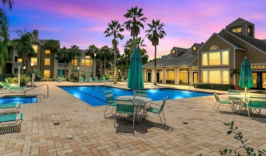 a swimming pool with outdoor seating and yard