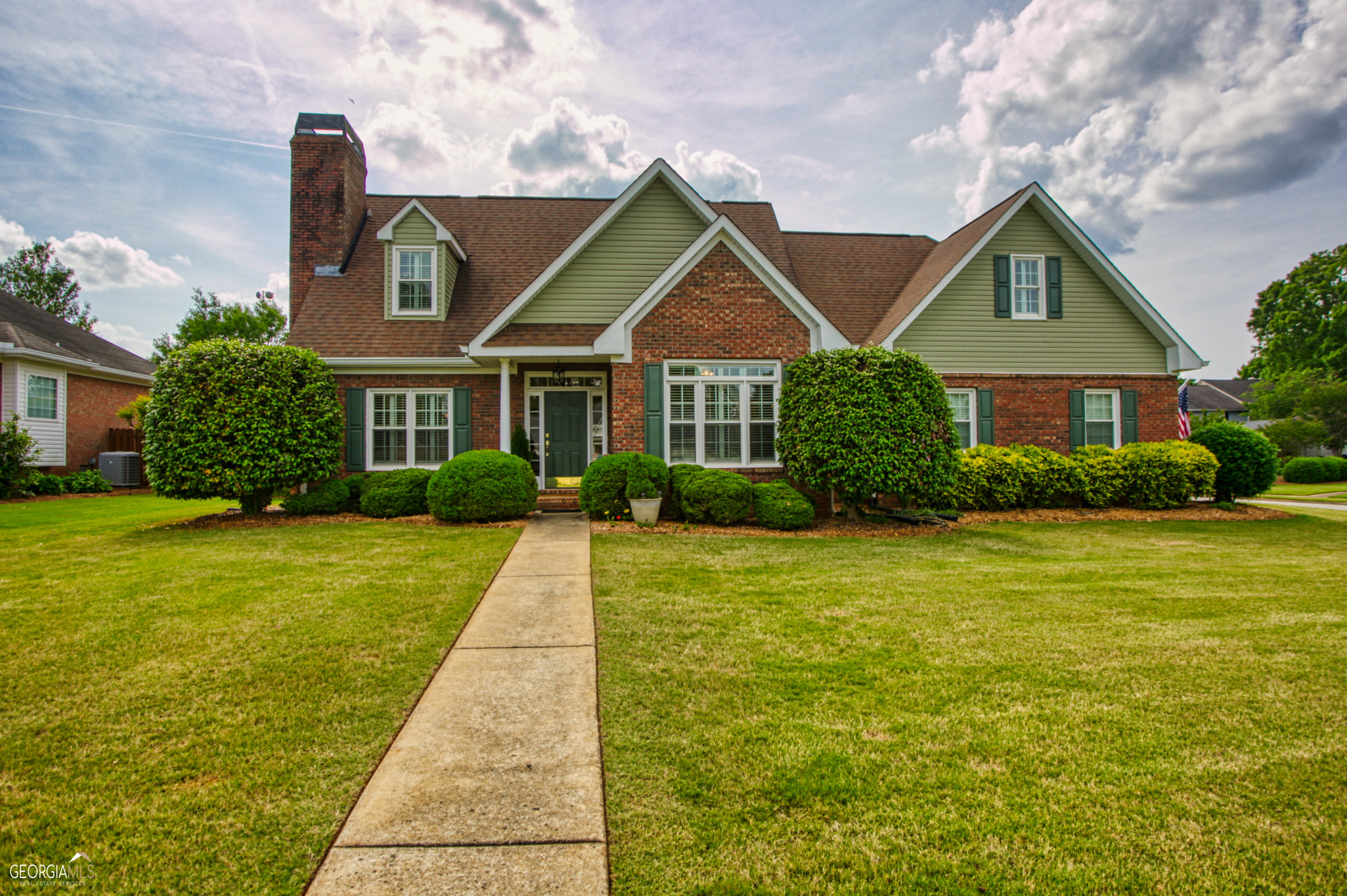 a front view of house with yard and green space