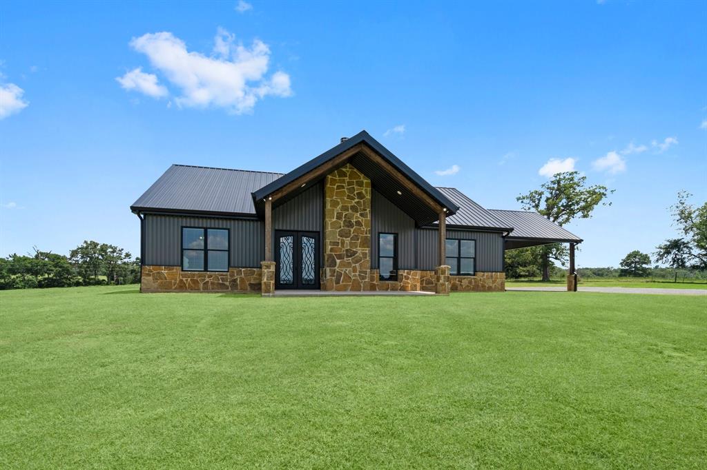 a front view of a house with a garden