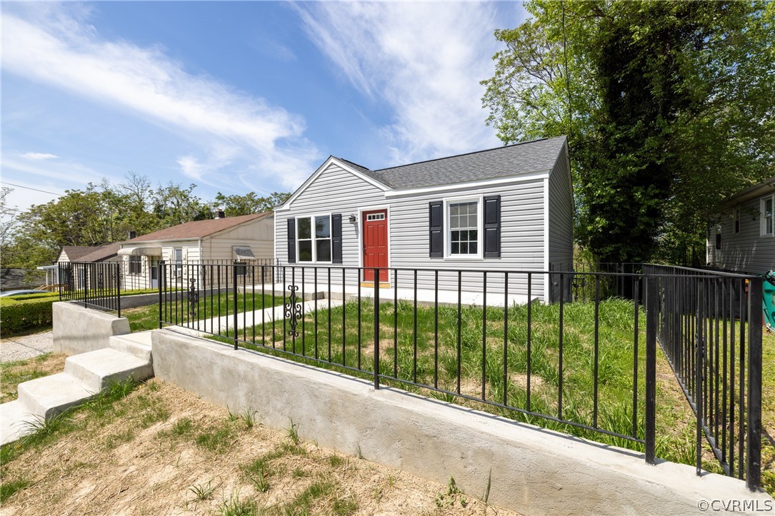 a view of a house with a wooden fence