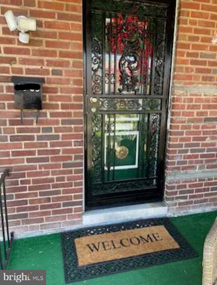 a view of a door and brick wall