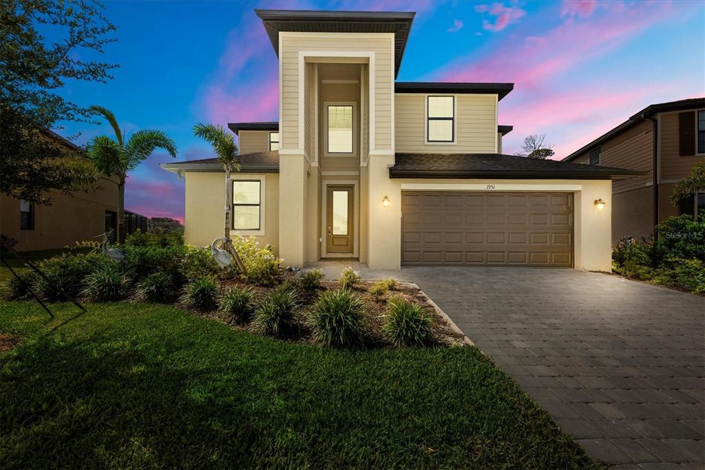 a front view of a house with a yard and garage