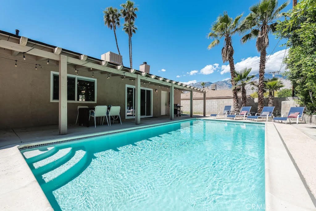 a swimming pool with outdoor seating and yard