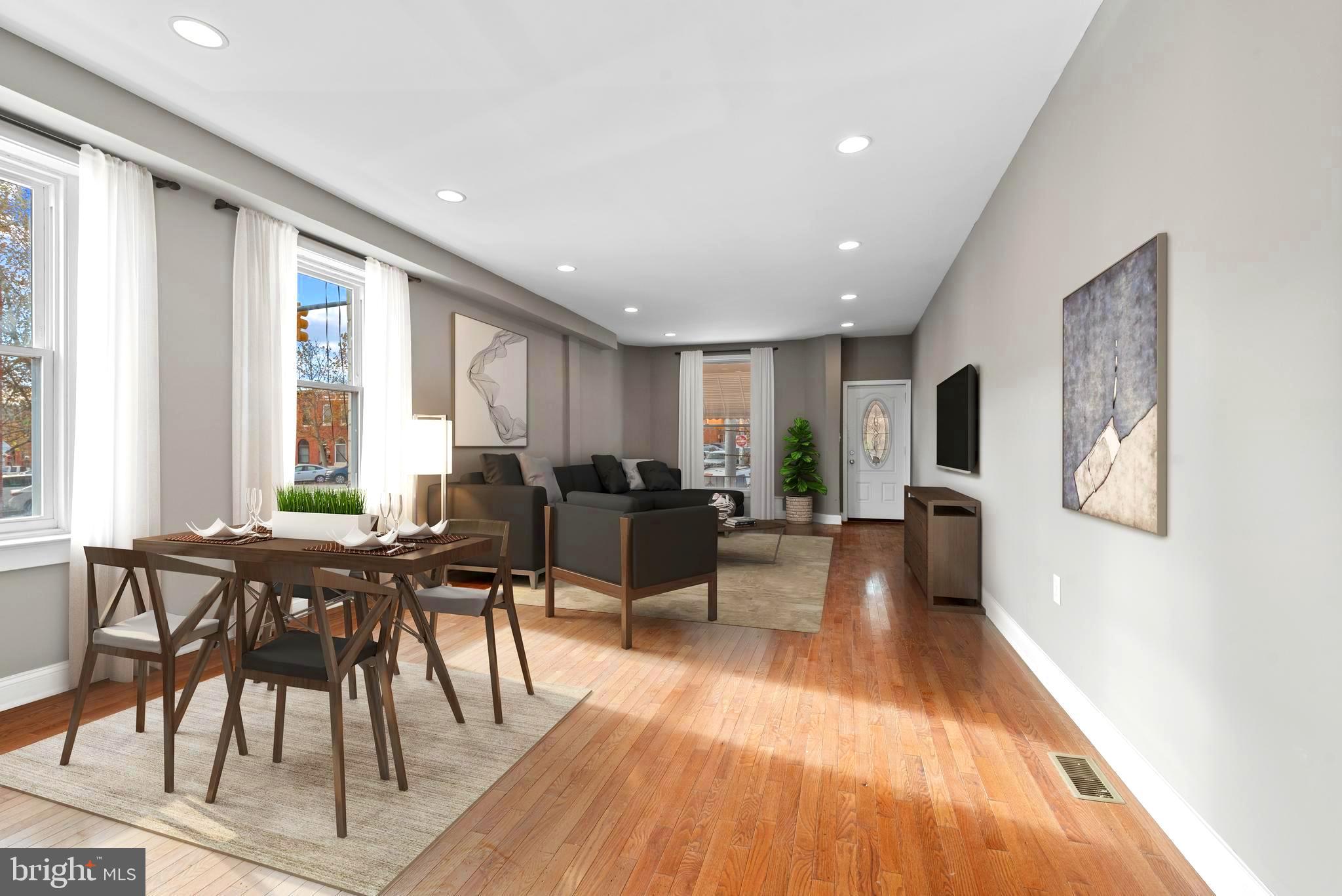 a living room with furniture wooden floor and a large window