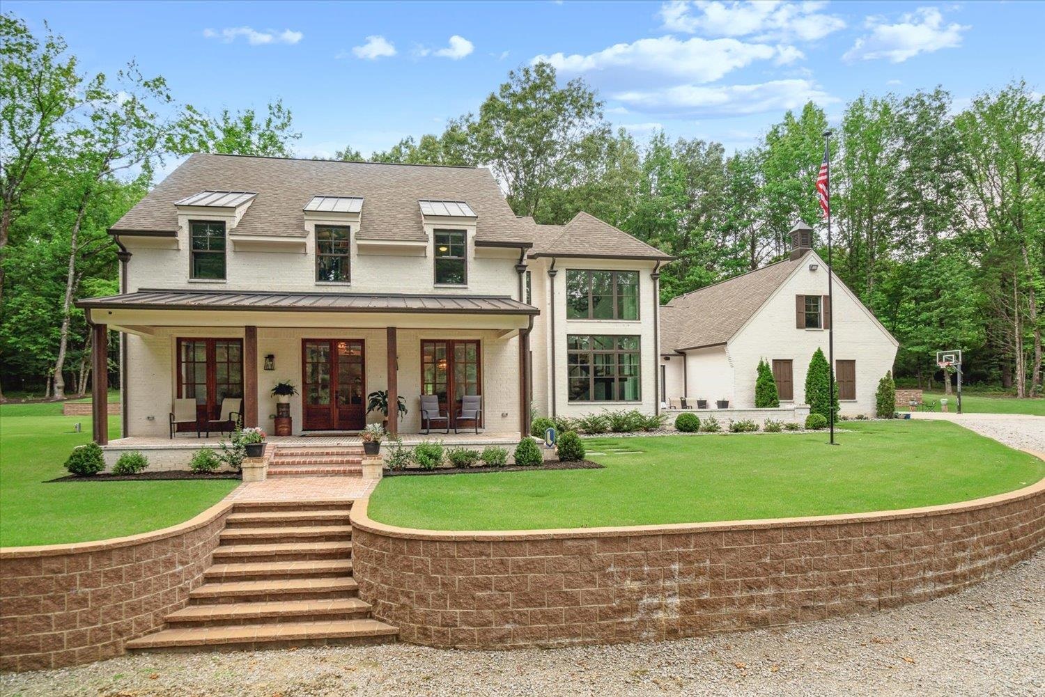 View of front of home with a front yard and covered porch