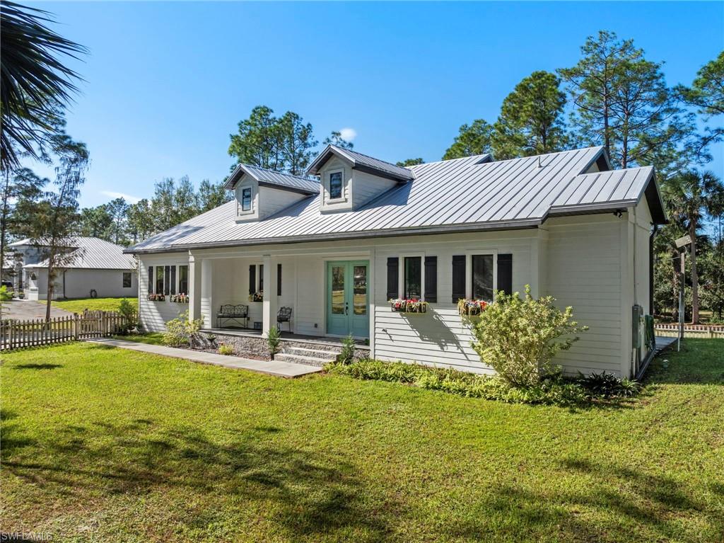 a front view of house with yard having outdoor seating