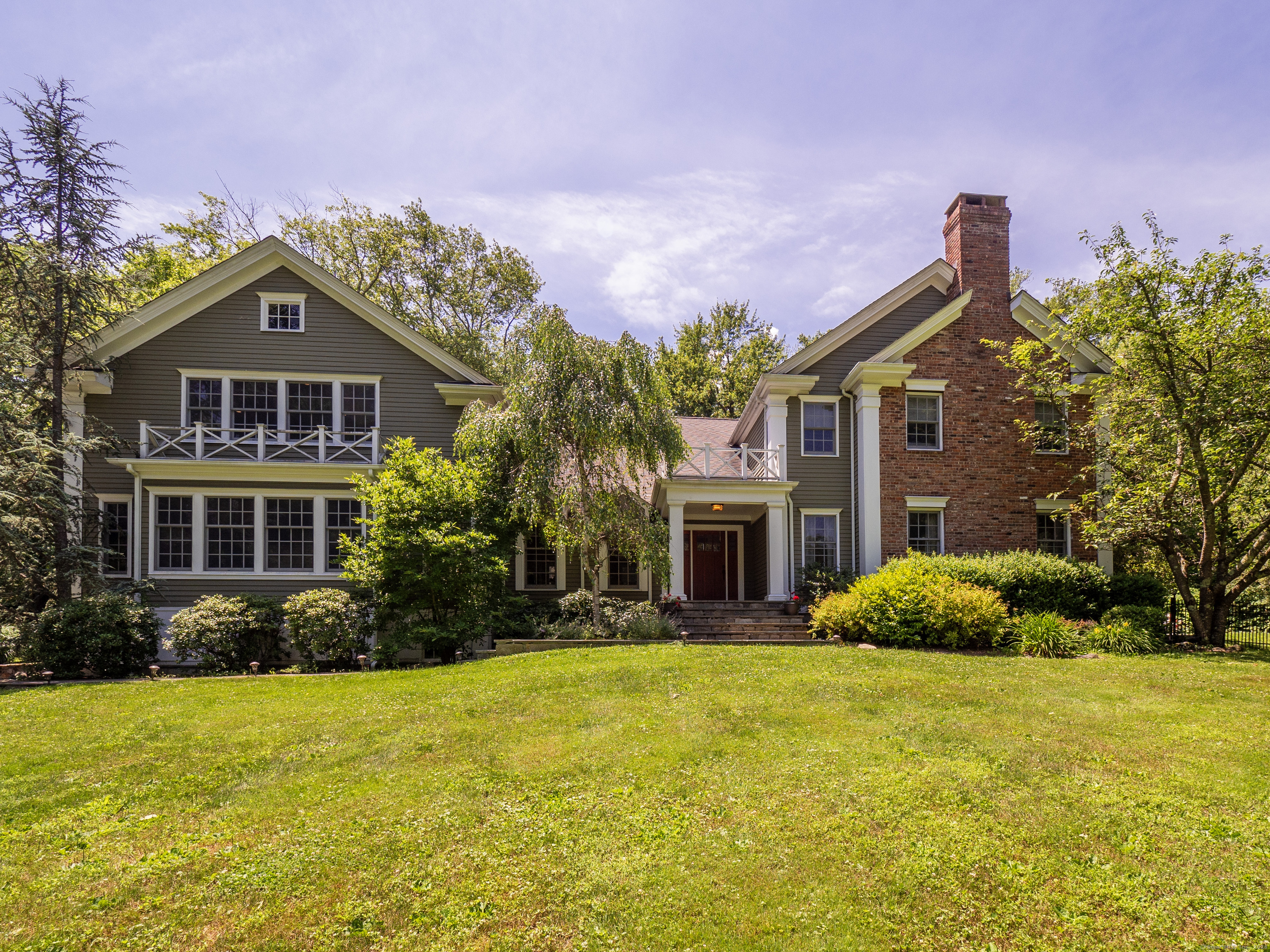 a front view of house with yard and trees around