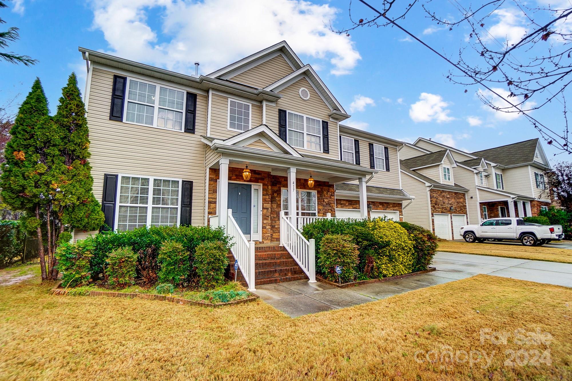 a front view of a residential apartment building with a yard