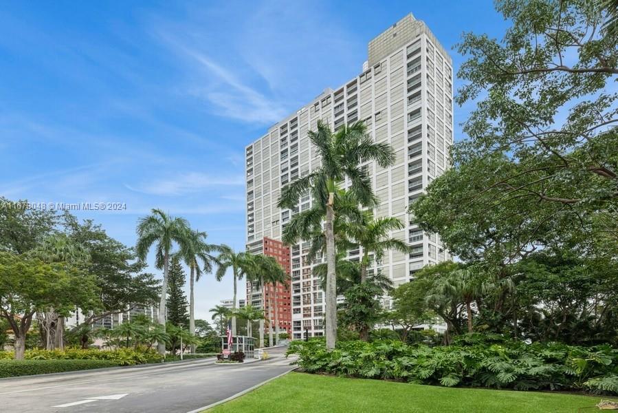 a view of a tall building next to a road