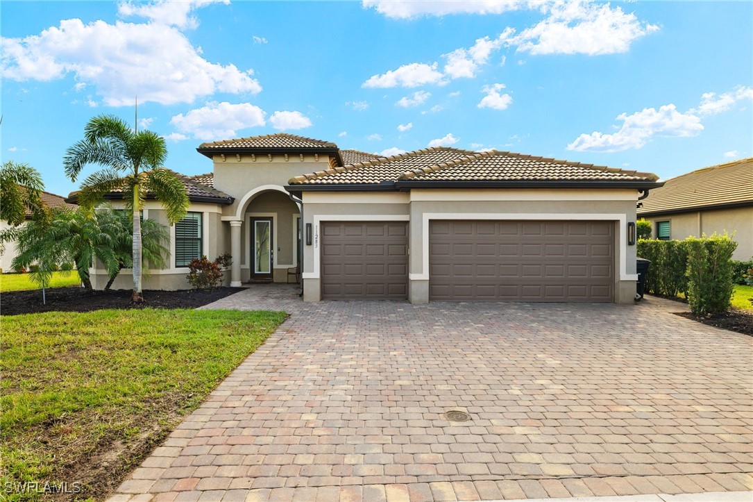 a front view of a house with a yard and garage