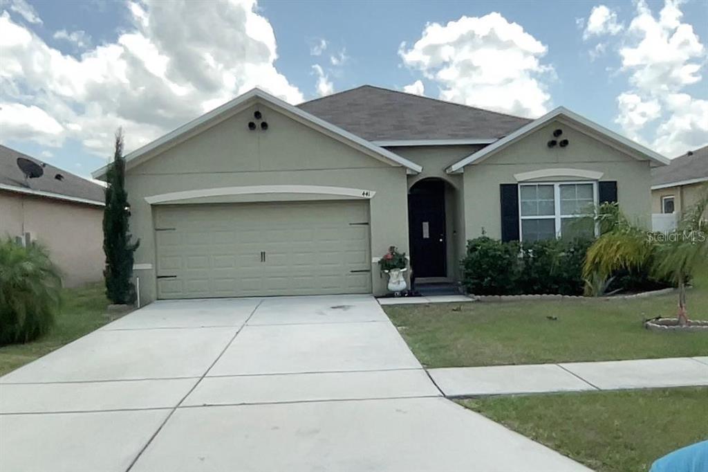 a front view of a house with a garden and garage