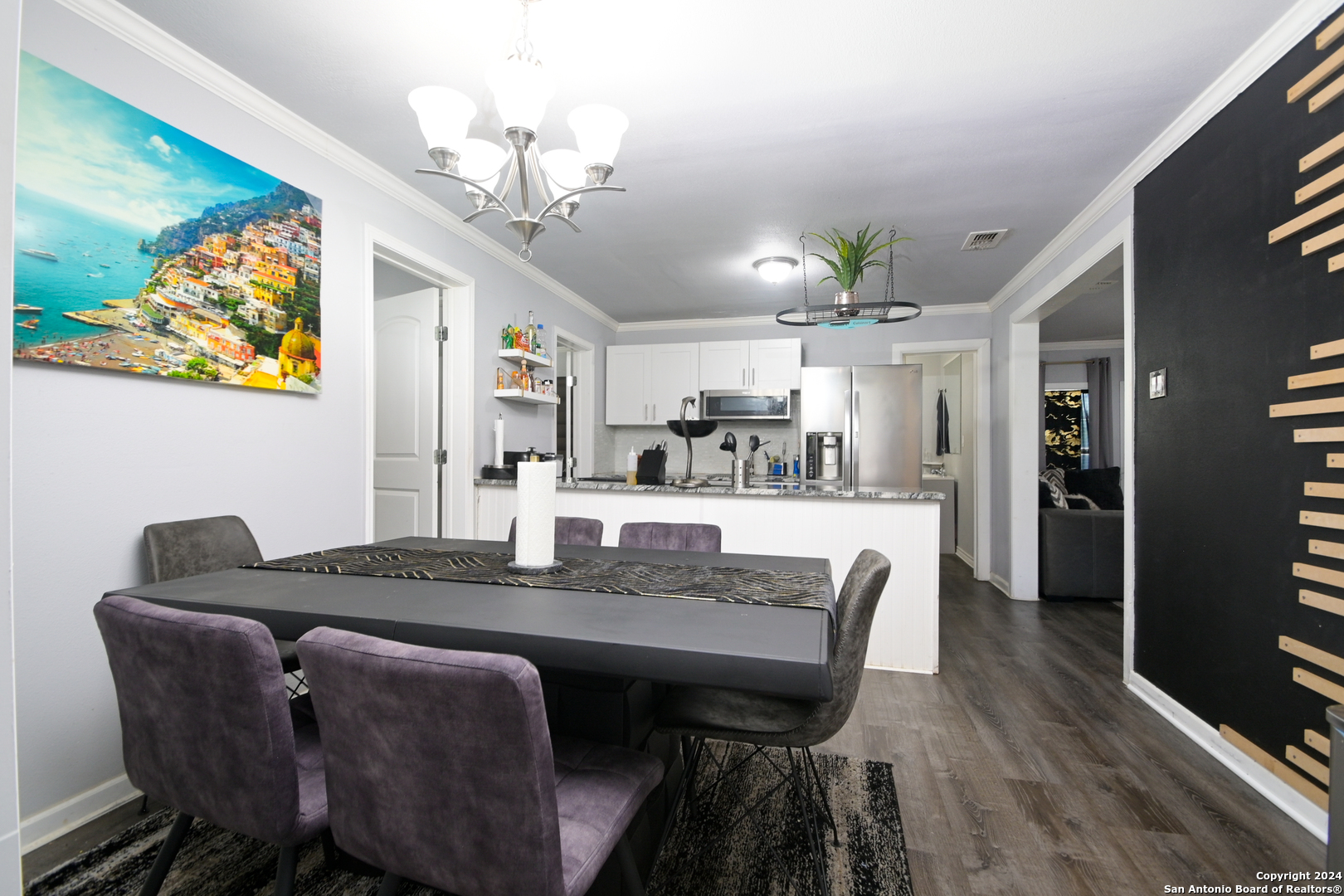 a view of a dining room with furniture and wooden floor