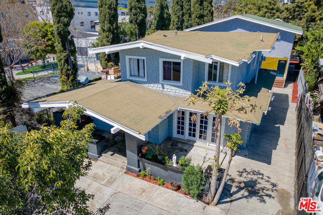 an aerial view of a house with yard