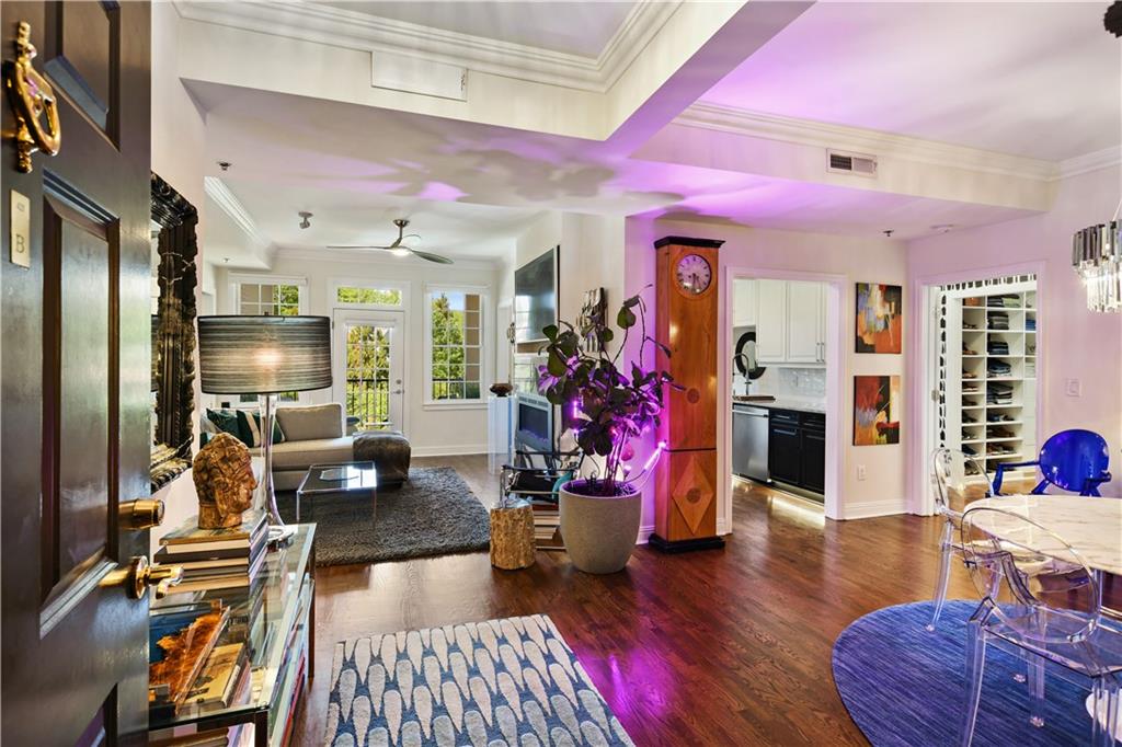 a living room with furniture or wooden floor and a large window