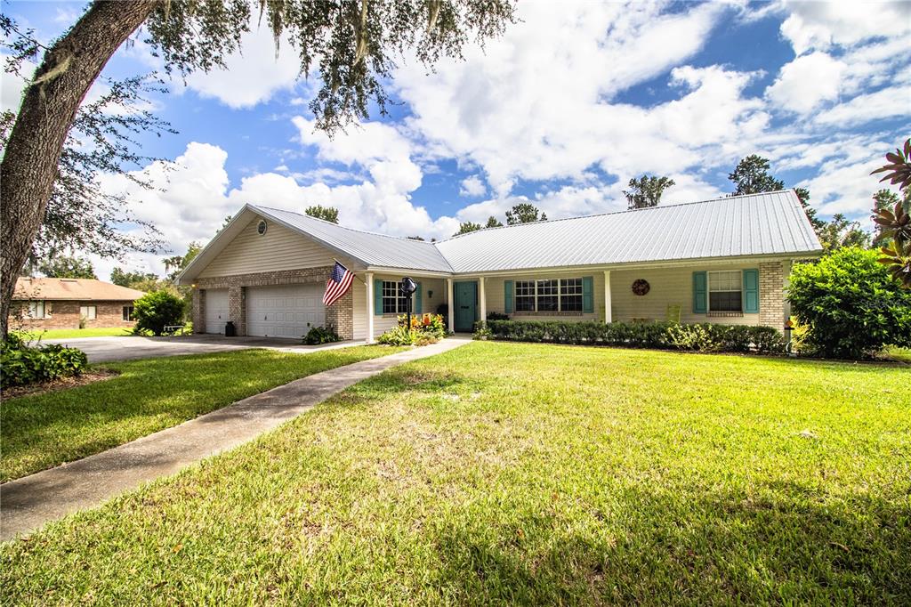 a front view of house with yard and green space