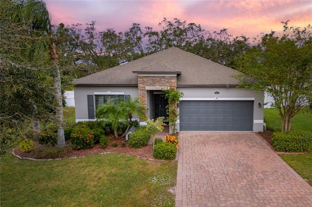 a front view of a house with a yard and garage