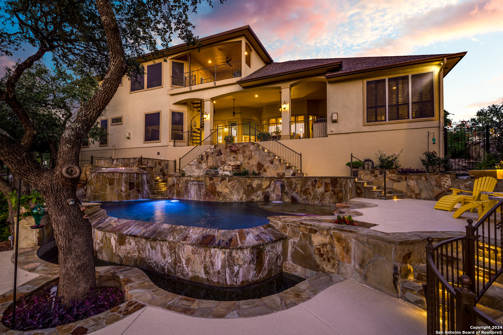 a view of a house with swimming pool and sitting area