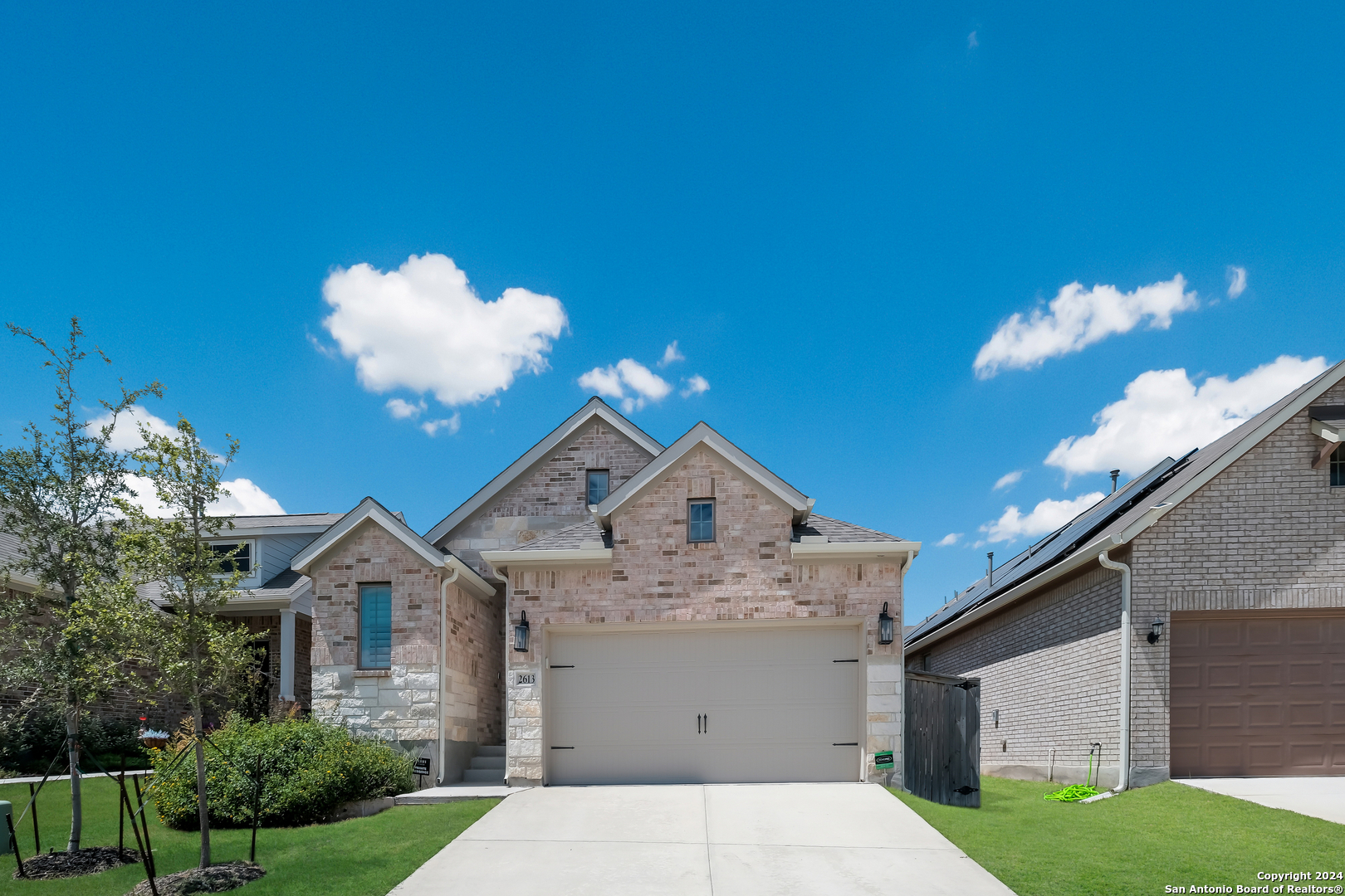 a front view of a house with a yard