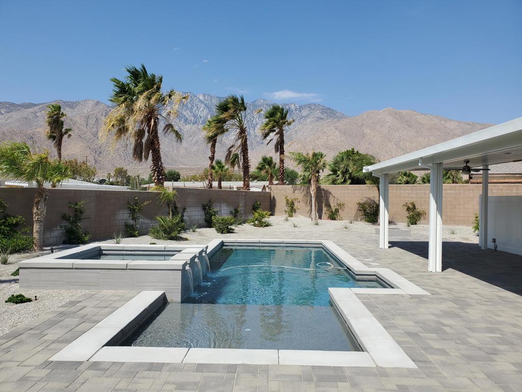 a view of a swimming pool with a lounge chair