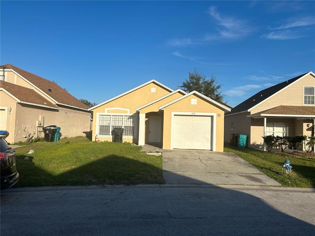 a front view of a house with a yard and garage