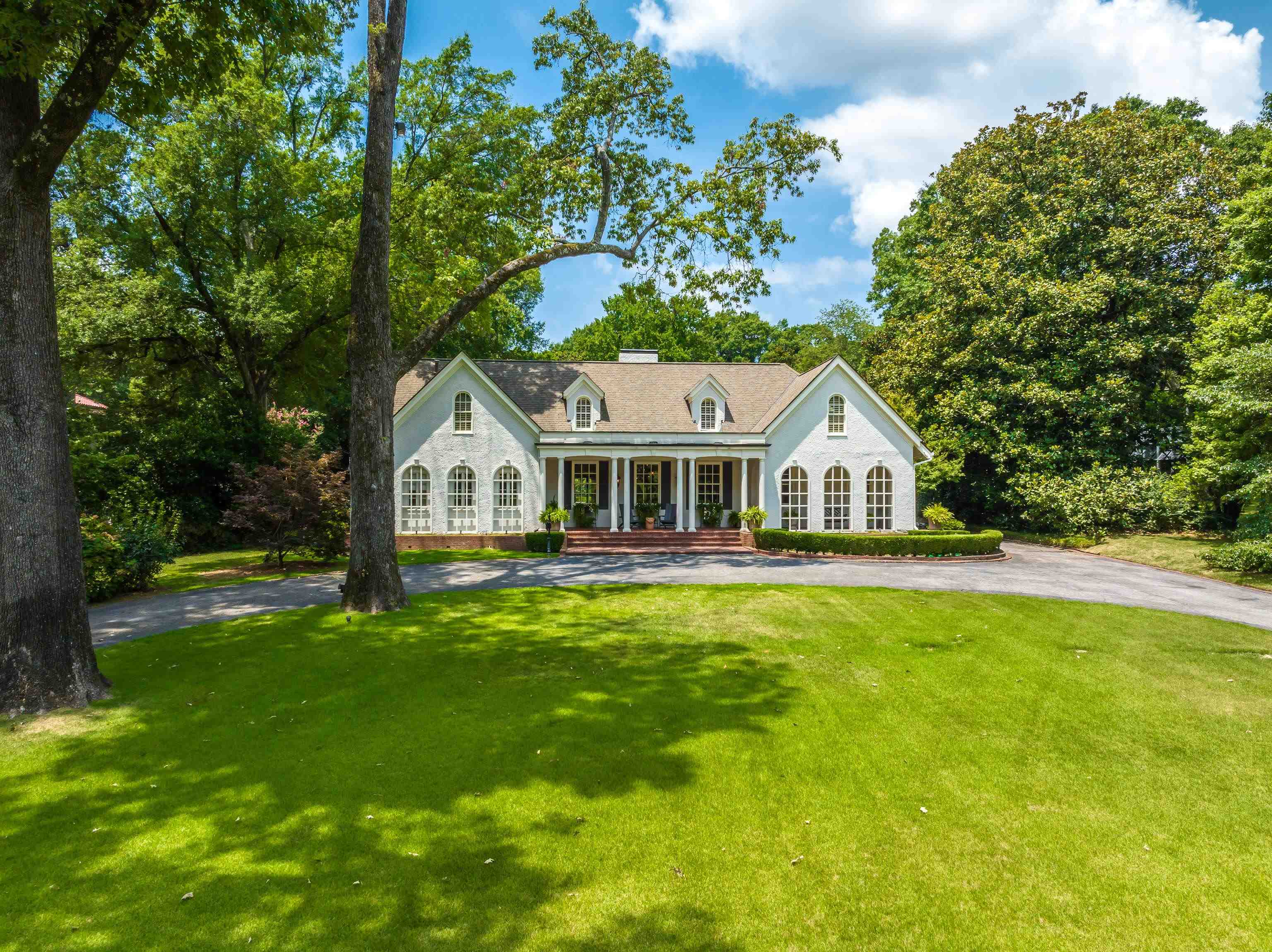 a front view of house with yard and green space