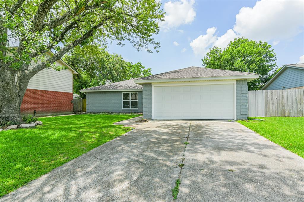 a front view of house with yard and trees