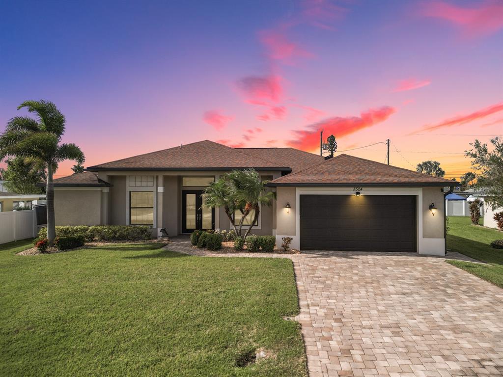 a front view of a house with a yard and garage