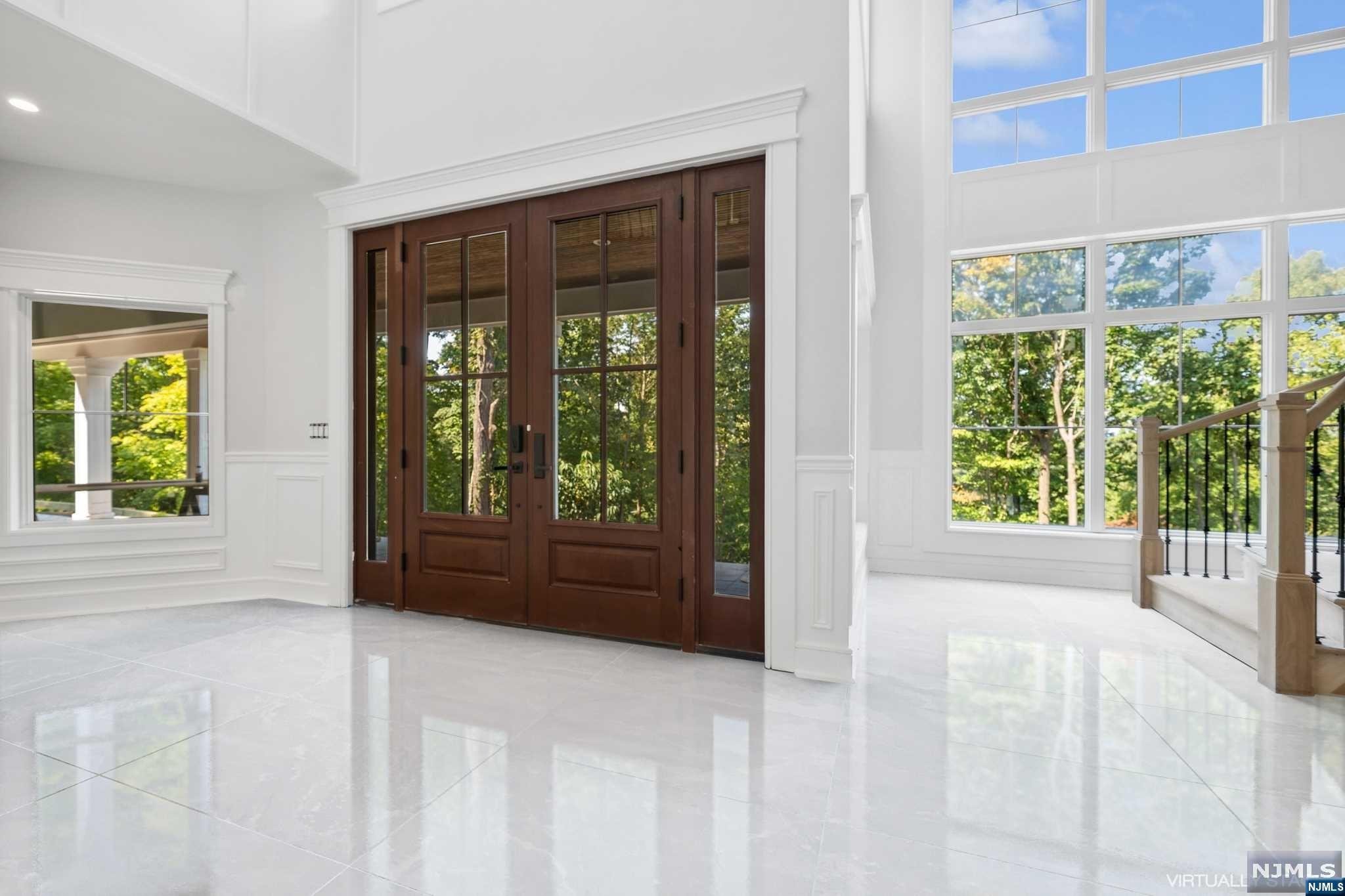 a view of an entryway with wooden floor and garden