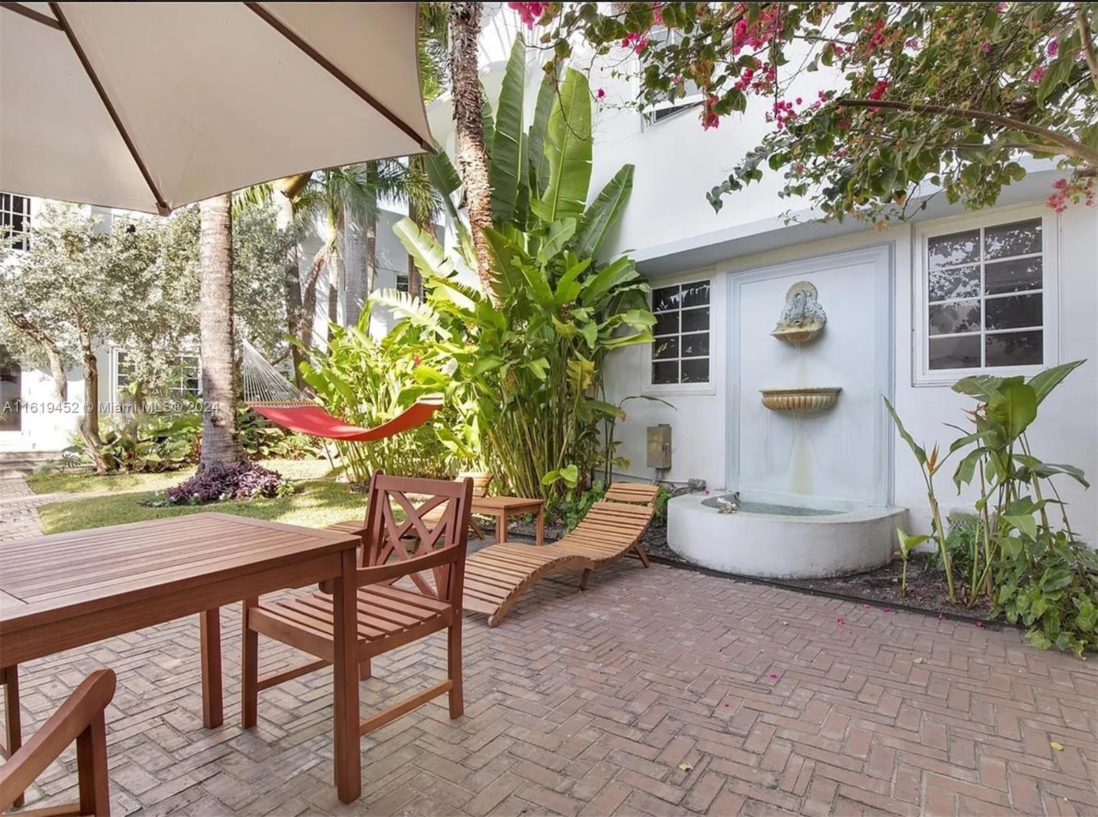 a backyard of a house with table and chairs