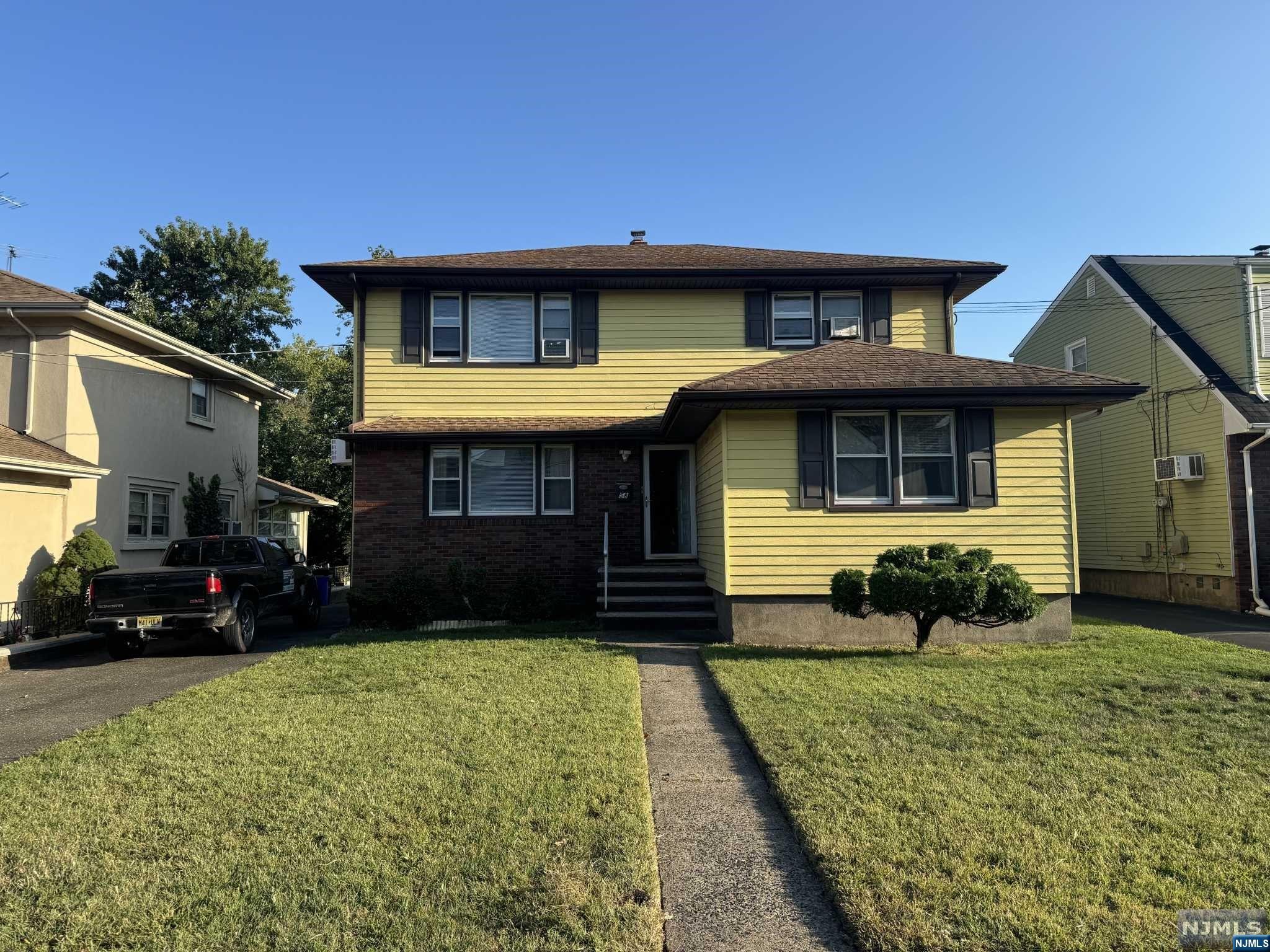 a front view of a house with a yard