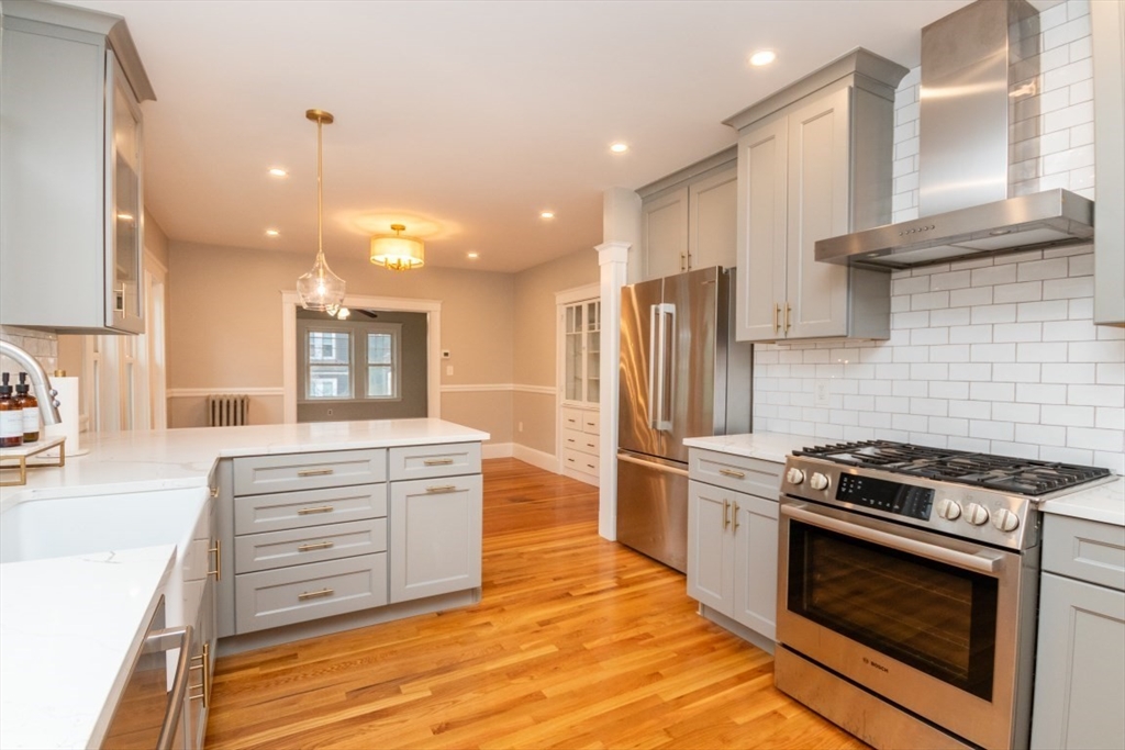 a kitchen with stainless steel appliances granite countertop a stove and a refrigerator