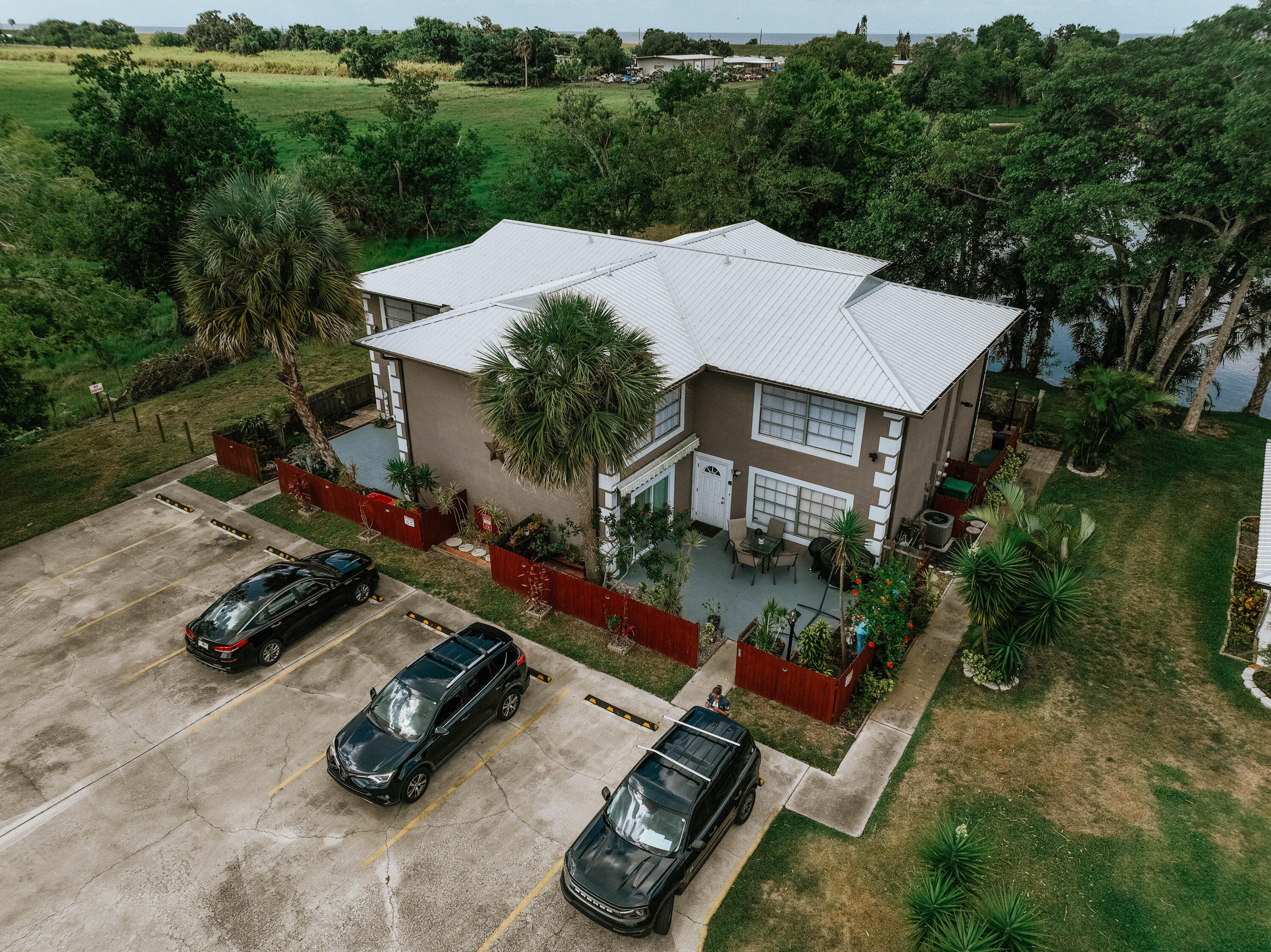 an aerial view of a house with garden space and street view