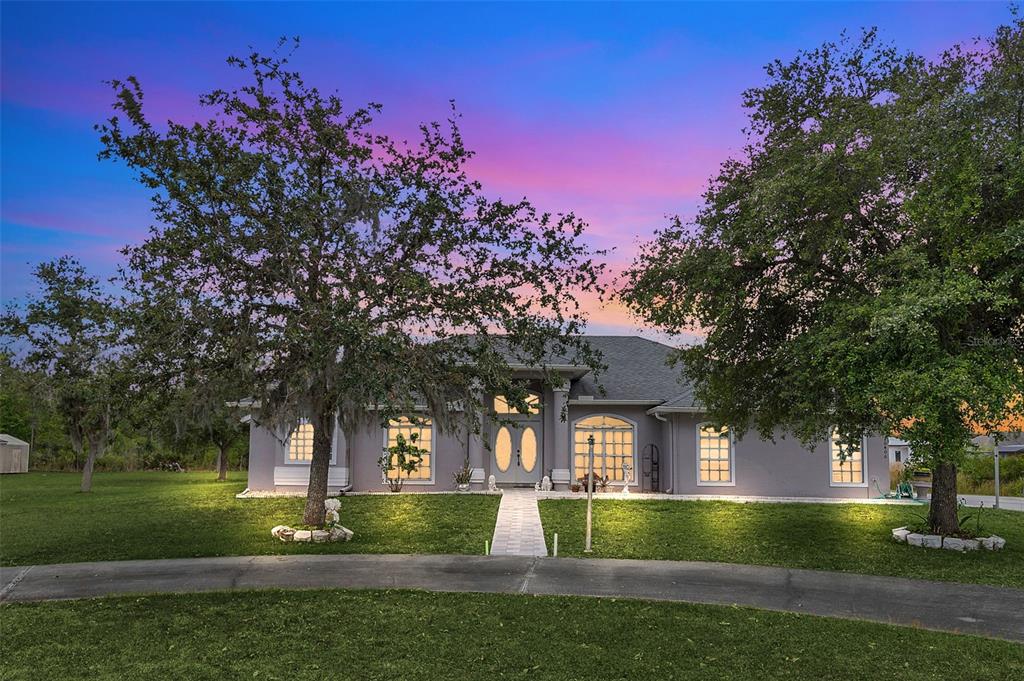 a front view of a house with a garden