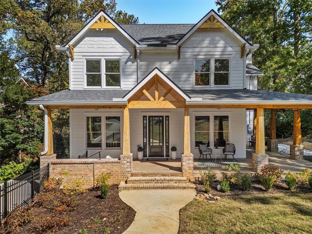 a front view of a house with a yard outdoor seating and garage