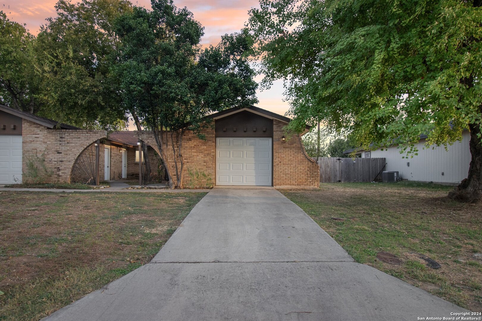 a front view of a house with a yard and a garage