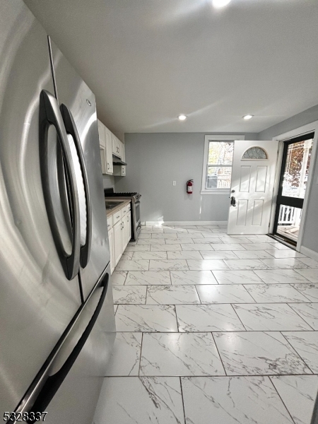 a spacious bathroom with a mirror and a shower