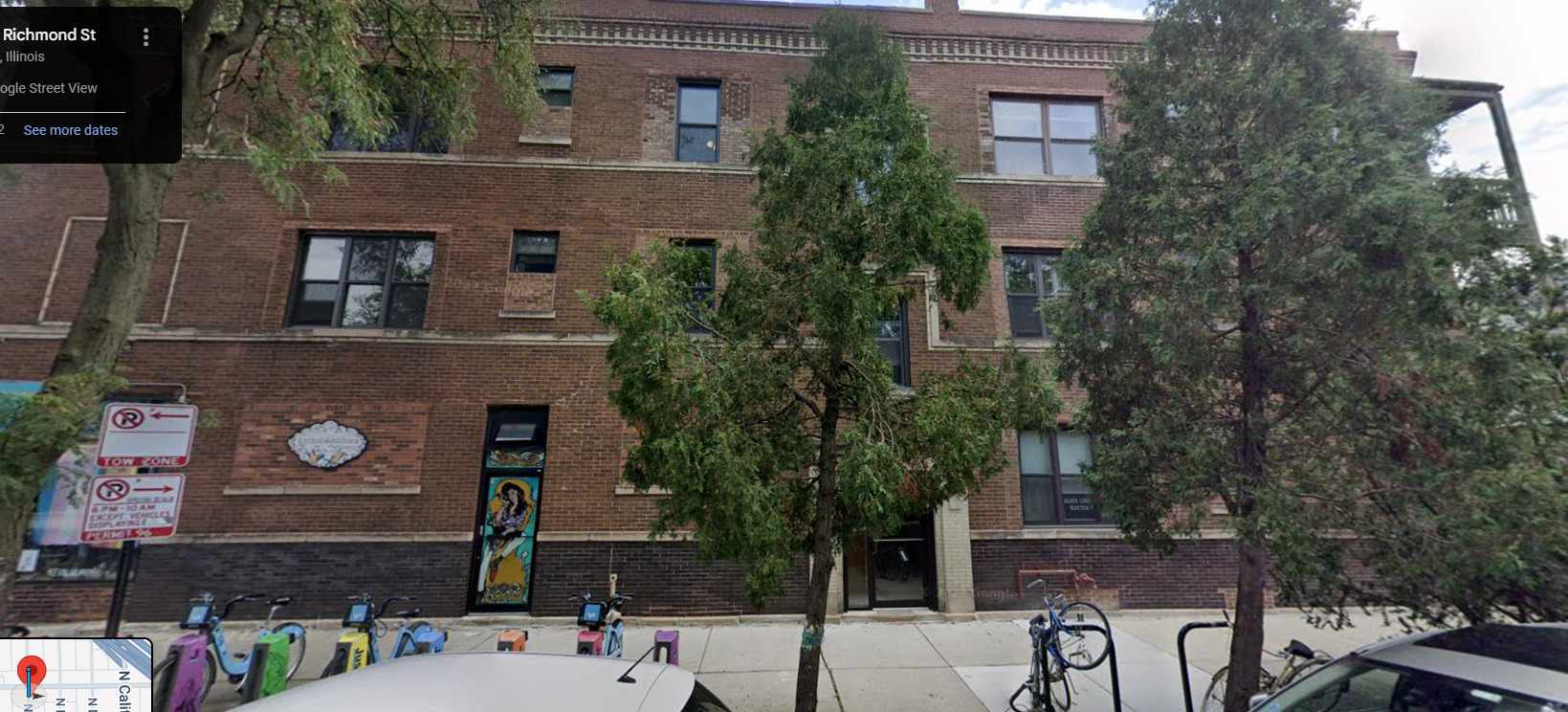 a brick building with a tree in front of it