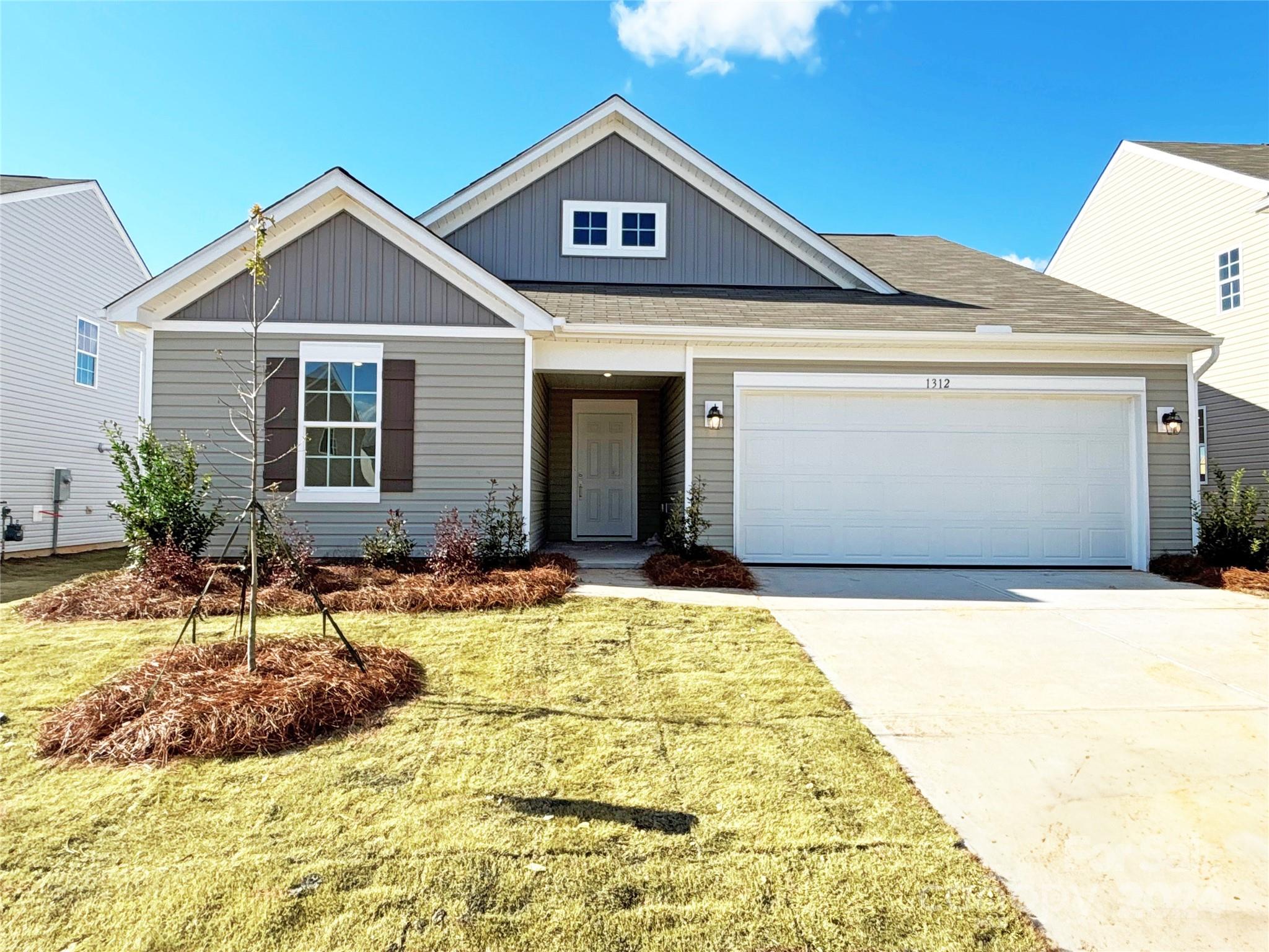 a view of a house with yard and sitting area