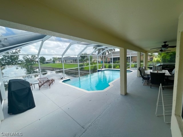 a view of a patio with a table chairs and a backyard