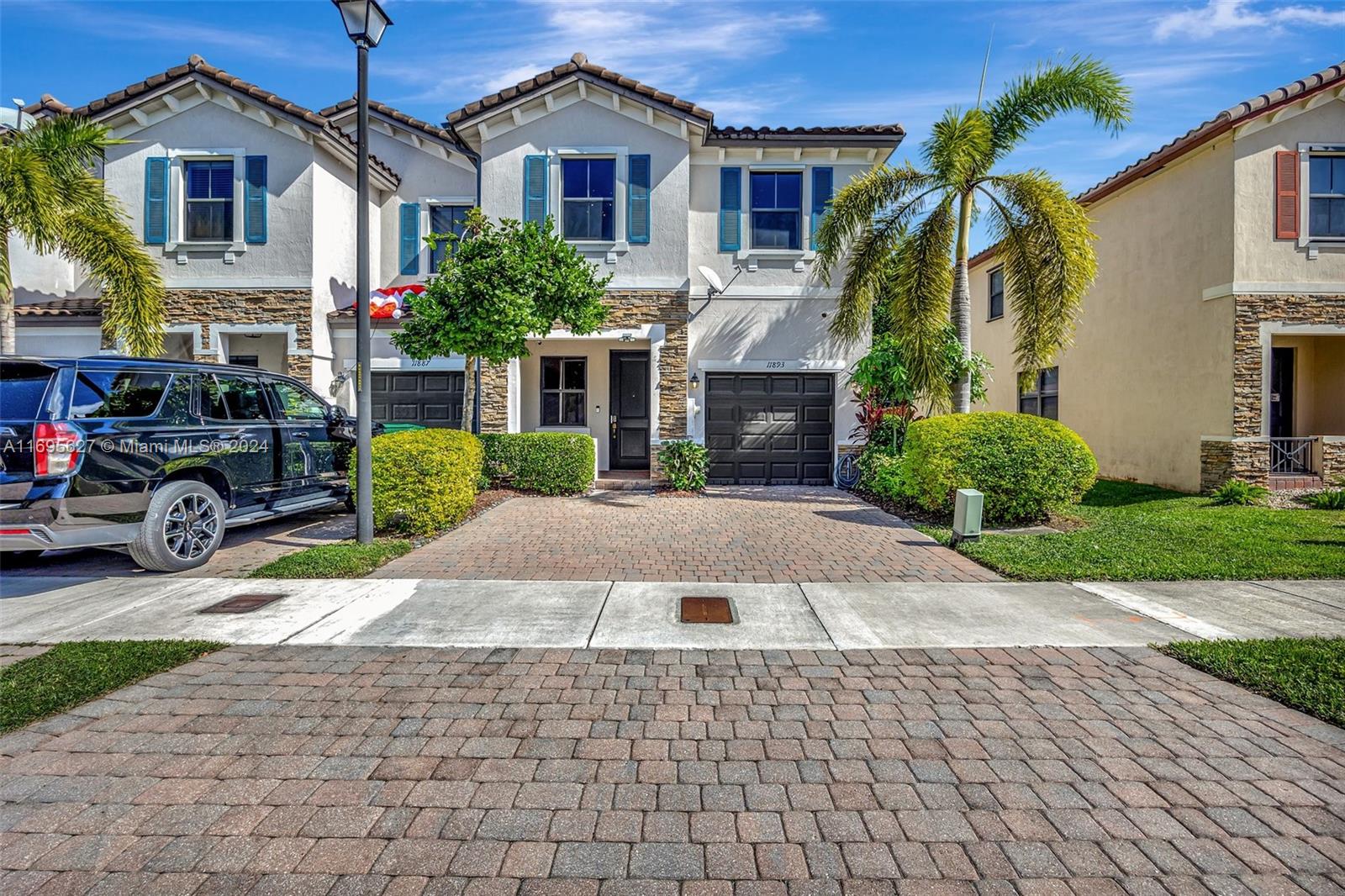 a front view of a house with a yard and a garage