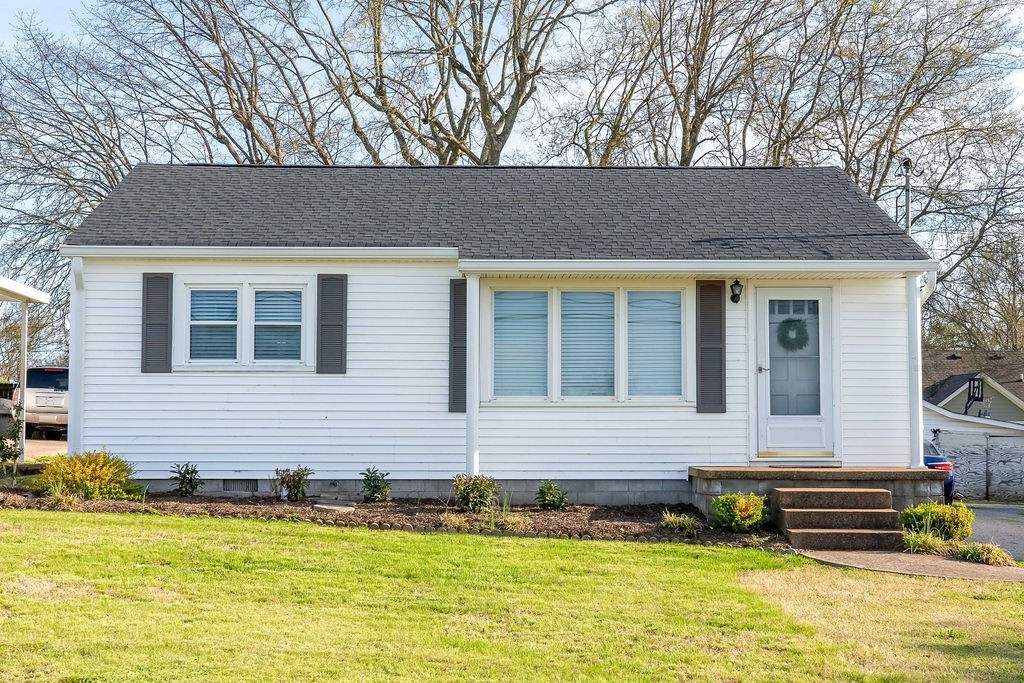 a front view of a house with a yard